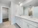 Clean, white bathroom with double vanity, large mirror, and a glass-enclosed shower at 7120 Saltpeter St, Charlotte, NC 28215