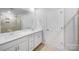 Bathroom featuring a double vanity with white cabinets and a large mirror at 7120 Saltpeter St, Charlotte, NC 28215