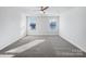 Bright, carpeted bedroom with two windows allowing for lots of natural light at 7120 Saltpeter St, Charlotte, NC 28215