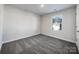Bright bedroom with plush carpet and natural light from the window overlooking the front yard at 7120 Saltpeter St, Charlotte, NC 28215
