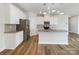 Modern kitchen with white cabinets, stainless steel appliances, and a spacious island at 7120 Saltpeter St, Charlotte, NC 28215
