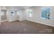 Upstairs landing area featuring neutral paint, plush carpet, and lots of natural light at 7120 Saltpeter St, Charlotte, NC 28215
