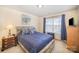 Inviting bedroom with a comfortable bed, neutral walls, and a bright window view at 7361 Sun Dance Dr, Fort Mill, SC 29707