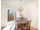 Bright dining area with access to an outdoor deck, chandelier, and seating for four at 7361 Sun Dance Dr, Fort Mill, SC 29707