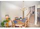 The dining area boasts a chandelier, seating for four, and easy access to the staircase at 7361 Sun Dance Dr, Fort Mill, SC 29707