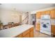 Open kitchen and dining area features an island and stainless steel appliances, connecting seamlessly with the staircase at 7361 Sun Dance Dr, Fort Mill, SC 29707