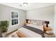 This bedroom features neutral walls, a soft bed, wood bedside tables, and a bright window that floods the space with natural light at 755 Ottawa Dr, Rock Hill, SC 29732