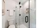 Elegant bathroom featuring a marble shower, black hardware, and a toilet at 7801 Snowden Ln, Charlotte, NC 28270