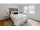 Bright bedroom featuring a plush bed, bedside tables with lamps, and natural light from the large windows at 7801 Snowden Ln, Charlotte, NC 28270