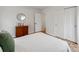 Bright bedroom with hardwood floors, closet doors, and a view into a bathroom at 7801 Snowden Ln, Charlotte, NC 28270