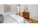 Well-lit bedroom with hardwood floors, stylish decor, and a view into a bathroom at 7801 Snowden Ln, Charlotte, NC 28270