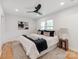 Cozy bedroom with a queen bed, stylish bedding, hardwood floors and plenty of natural light at 7801 Snowden Ln, Charlotte, NC 28270