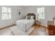 Charming bedroom with wood floors, natural light, stylish side tables, and neutral decor at 7801 Snowden Ln, Charlotte, NC 28270