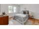 Cozy bedroom featuring a bed, wood floors, natural light, and stylish decor at 7801 Snowden Ln, Charlotte, NC 28270