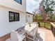 Deck with outdoor dining furniture, overlooking a sprawling backyard and mature trees at 7801 Snowden Ln, Charlotte, NC 28270