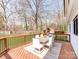 Outdoor deck area with dining table and chairs, overlooking a well-manicured backyard at 7801 Snowden Ln, Charlotte, NC 28270