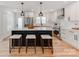 Modern white kitchen featuring a black island with bar stool seating and stainless steel appliances at 7801 Snowden Ln, Charlotte, NC 28270