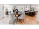 Open concept floor plan with a modern kitchen featuring a black island and adjoining dining area at 7801 Snowden Ln, Charlotte, NC 28270