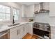 Bright kitchen featuring white cabinets, stainless steel appliances, and modern finishes at 7801 Snowden Ln, Charlotte, NC 28270