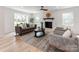 Cozy living room featuring a brick fireplace and comfortable seating at 7801 Snowden Ln, Charlotte, NC 28270