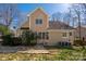 The rear exterior of the house features a manicured lawn, stone pathway, and mature trees at 7806 Spanish Oaks Dr, Waxhaw, NC 28173