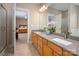 Bathroom featuring double sinks, granite countertops, modern fixtures, and an adjoined main bedroom at 7806 Spanish Oaks Dr, Waxhaw, NC 28173