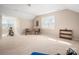 Expansive bonus room with bike, seating, and shelving, perfect for recreation or entertainment at 7806 Spanish Oaks Dr, Waxhaw, NC 28173