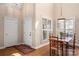 Bright dining room featuring hardwood floors, natural light, and an adjacent entryway at 7806 Spanish Oaks Dr, Waxhaw, NC 28173