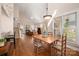 Open-concept dining area with hardwood floors and seamless access to the kitchen and living spaces at 7806 Spanish Oaks Dr, Waxhaw, NC 28173