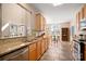 Open concept kitchen with stainless steel appliances, tile flooring, and breakfast nook at 7806 Spanish Oaks Dr, Waxhaw, NC 28173