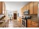 Open kitchen featuring stainless steel appliances, granite countertops, tile backsplash, and eat in breakfast nook at 7806 Spanish Oaks Dr, Waxhaw, NC 28173