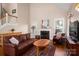 Bright living room featuring hardwood floors, fireplace, and a comfortable seating arrangement at 7806 Spanish Oaks Dr, Waxhaw, NC 28173