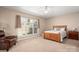 Cozy main bedroom with a plush chair, light-filled window, and soft carpet at 7806 Spanish Oaks Dr, Waxhaw, NC 28173