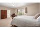 Comfortable main bedroom featuring a queen sized bed, a window, and neutral decor at 7806 Spanish Oaks Dr, Waxhaw, NC 28173
