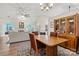 Dining room showcasing a wooden table, chairs, and built-in cabinet with glass doors at 8402 Albury Walk Ln, Charlotte, NC 28277