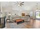 Cozy living room featuring wood flooring, a large sectional, a fireplace, and an open floorplan at 8402 Albury Walk Ln, Charlotte, NC 28277