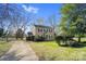 A view of the front yard of a two-story home showcasing its lawn and landscaping at 8501 Golf Ridge Dr, Charlotte, NC 28277