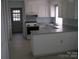 Functional kitchen with white cabinets, neutral countertops, and modern appliances at 8501 Golf Ridge Dr, Charlotte, NC 28277