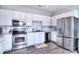 Bright kitchen featuring stainless steel appliances and white cabinetry at 8722 Arrowhead Place Ln, Cornelius, NC 28031