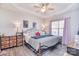 Spacious main bedroom with a tray ceiling, fan, and large window at 8722 Arrowhead Place Ln, Cornelius, NC 28031