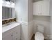 Well-maintained bathroom with decorative mirror, toilet, and white wainscoting at 898 Sage Field Ln, Lincolnton, NC 28092