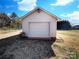 A detached one-car garage with white siding, complemented by a well-maintained yard and partial blue skies at 898 Sage Field Ln, Lincolnton, NC 28092