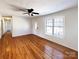 Spacious living room featuring gleaming hardwood floors, ceiling fan, and a large window at 898 Sage Field Ln, Lincolnton, NC 28092