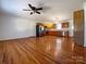 Bright, open living area with hardwood floors, ceiling fan, and a seamless transition into the eat-in kitchen at 898 Sage Field Ln, Lincolnton, NC 28092