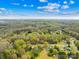 Wide aerial shot showcases the verdant landscape, residential area, and picturesque sky above at 9136 Ladson Rd, Indian Land, SC 29707