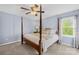 Comfortable bedroom features a four poster bed, plush carpet, and a ceiling fan at 9136 Ladson Rd, Indian Land, SC 29707