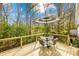 Relaxing outdoor deck with a table, chairs, and shade umbrella, perfect for entertaining at 9136 Ladson Rd, Indian Land, SC 29707