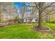 Charming home exterior featuring a well-maintained lawn, mature trees, and a lovely split-rail fence at 9136 Ladson Rd, Indian Land, SC 29707