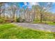 Well-manicured lawn leads to the house with a charming split-rail fence and mature trees at 9136 Ladson Rd, Indian Land, SC 29707