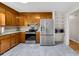 Cozy kitchen with stainless steel appliances, natural wood cabinets, and ample counter space perfect for cooking at 9136 Ladson Rd, Indian Land, SC 29707